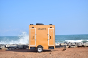 a blackgate restrooom unit by the sea at Tema Beach Road